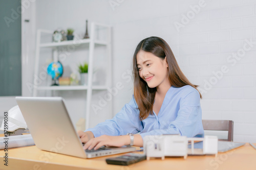 Asian architect man and woman working with laptop and blueprints,engineer inspection in workplace for architectural plan,sketching a construction project ,selective focus,Business concept