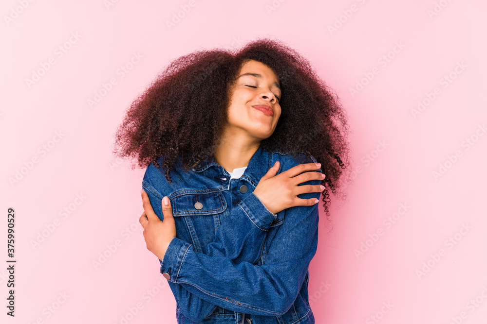 Young african american woman hugs, smiling carefree and happy. Young african american woman hugs, smiling carefree and happy.