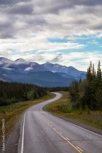 Beautiful View of a scenic road in the Northern Rockies during a sunny and cloudy morning sunrise. Taken in British Columbia, Canada. Nature Background