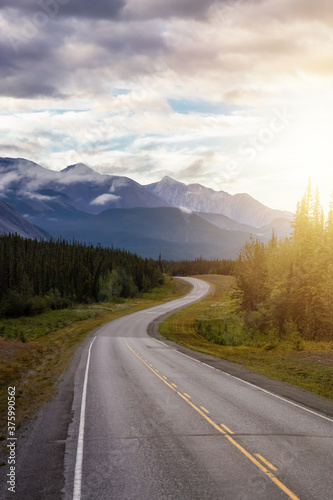 Beautiful View of a scenic road in the Northern Rockies during a sunny and cloudy morning sunrise. Taken in British Columbia, Canada. Nature Background