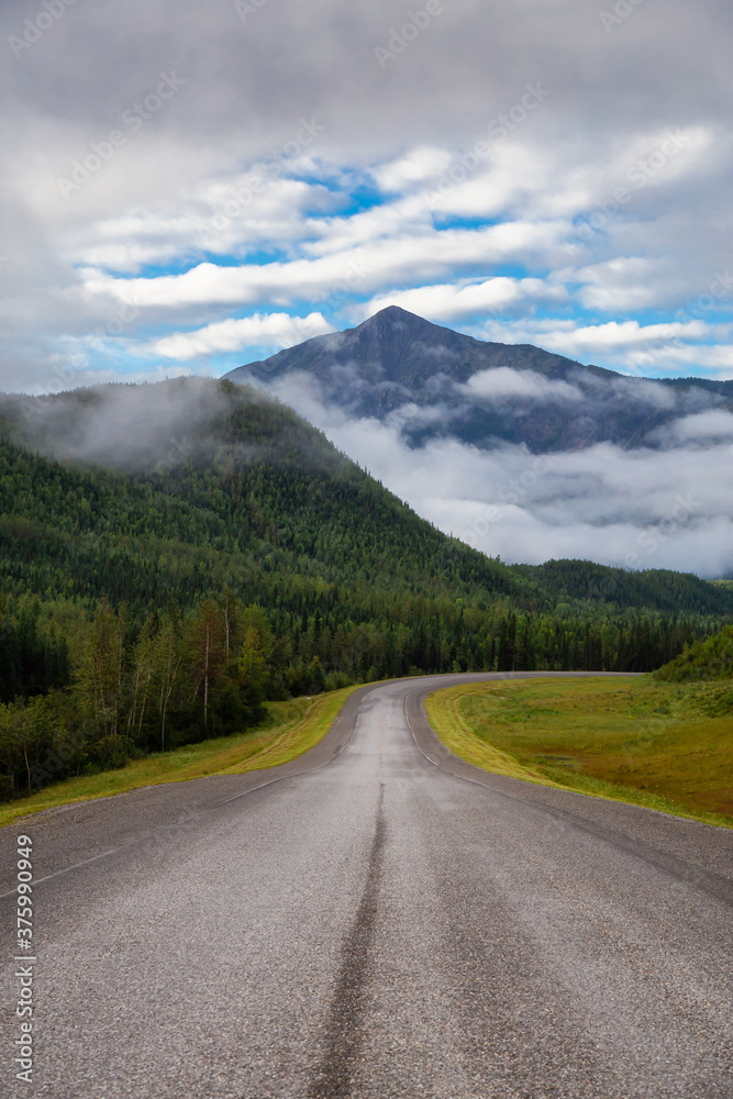 Beautiful View of a scenic road in the Northern Rockies during a sunny and cloudy morning sunrise. Taken in British Columbia, Canada. Nature Background Beautiful View of a scenic road in the Northern Rockies during a sunny and cloudy morning sunrise. Taken in British Columbia, Canada. Nature Background