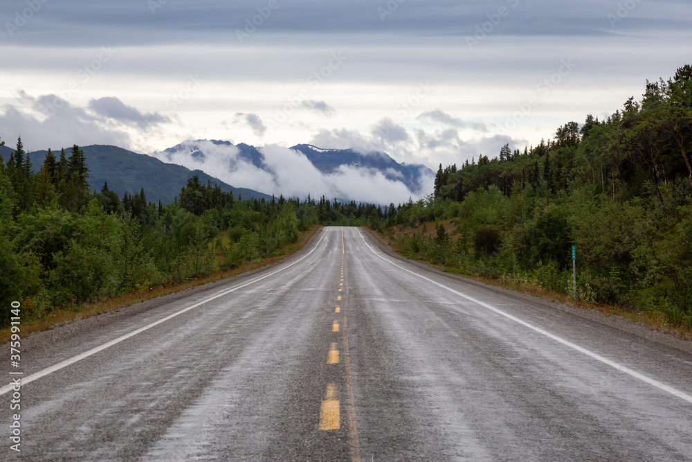 Beautiful View of a scenic road in the Northern Rockies during a sunny and cloudy morning. Taken in British Columbia, Canada. Nature Background Beautiful View of a scenic road in the Northern Rockies during a sunny and cloudy morning. Taken in British Columbia, Canada. Nature Background