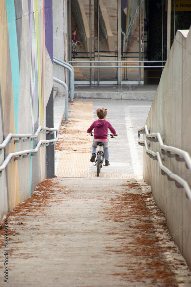 Unrecognizable little boy riding a bicycle