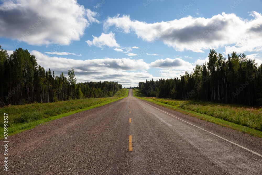 Beautiful View of a scenic road in the Northern Rockies during a sunny and cloudy day. Taken in British Columbia, Canada. Nature Background Panorama