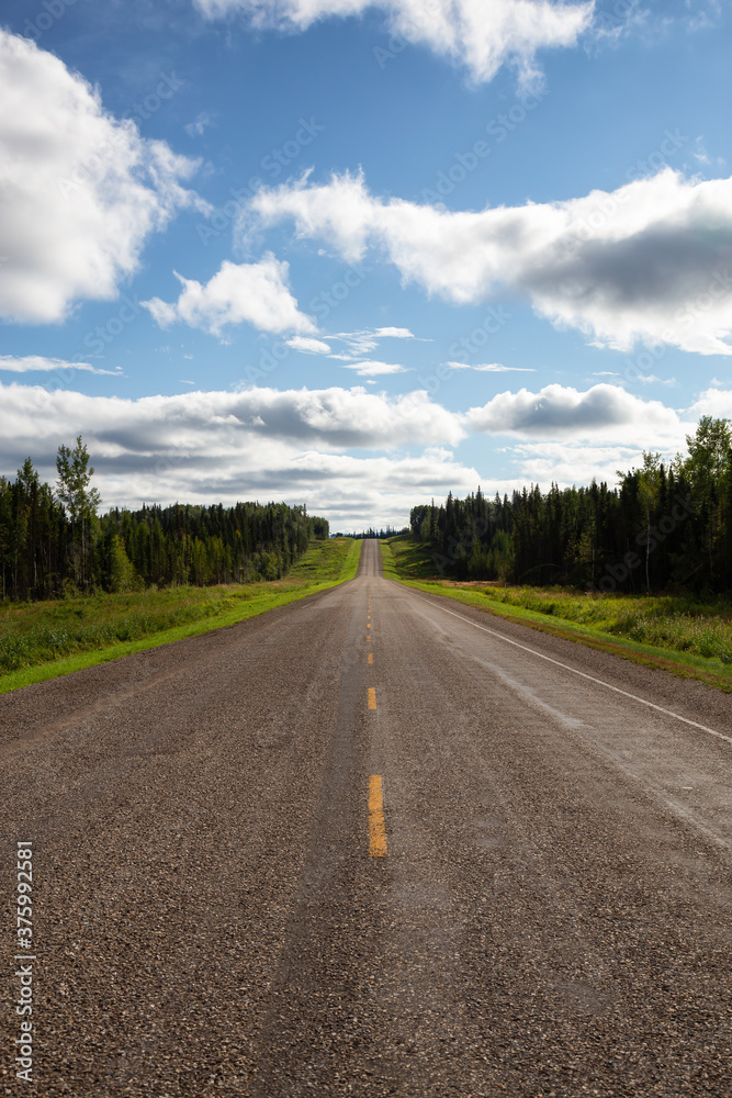 Beautiful View of a scenic road in the Northern Rockies during a sunny and cloudy day. Taken in British Columbia, Canada. Nature Background Panorama