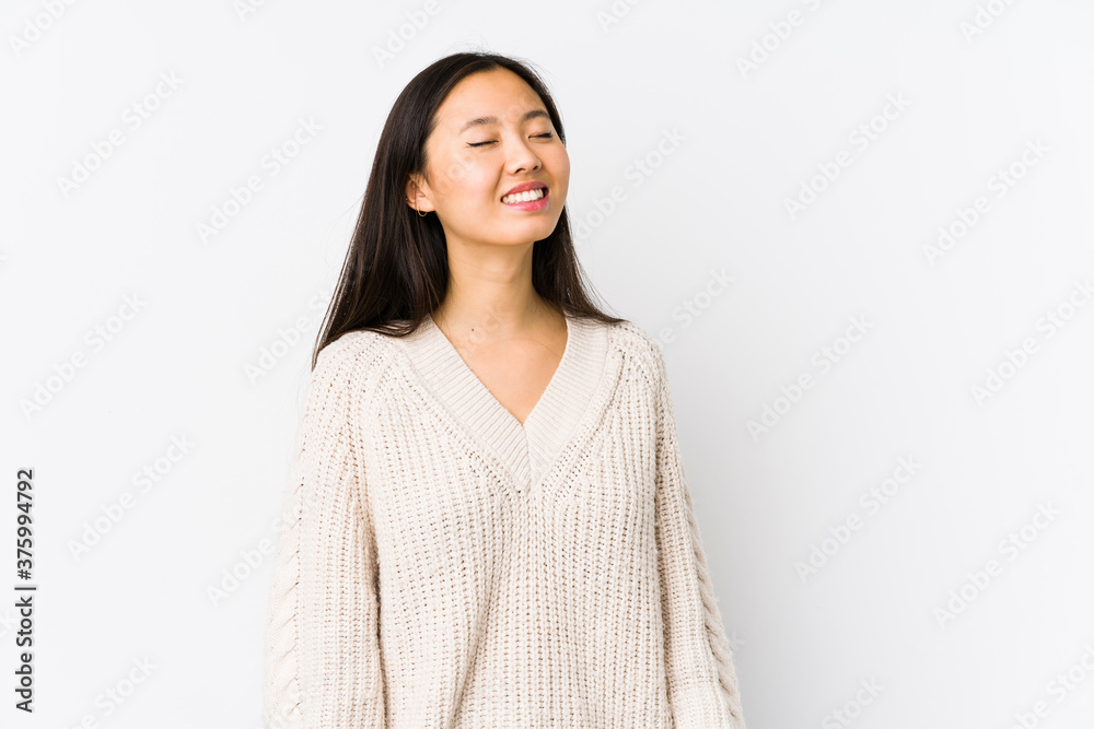 Young chinese woman isolated relaxed and happy laughing, neck stretched showing teeth. Young chinese woman isolated relaxed and happy laughing, neck stretched showing teeth.
