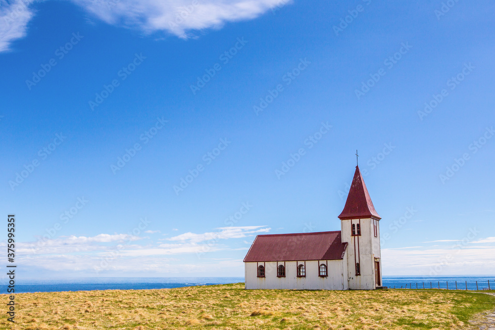 A red church, the landmark in Hellnar, Snaefellsnes, in Iceland, on a sunny day.