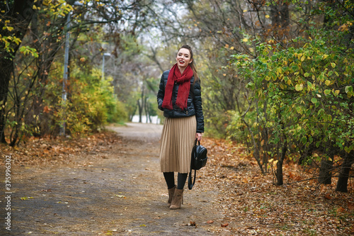 Portrait of a young beautiful woman in the Autumn city Park