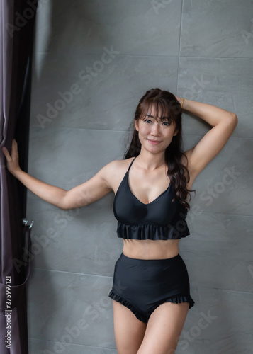 Asian woman in a sexy black bikini in a hotel © releon8211