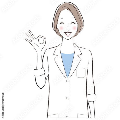 A woman doctor wearing white lab coat showing ok sign.