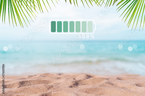 Fully charge battery 100% sign icon on natare summer beach on vacation day. Holiday long weekend relax time.