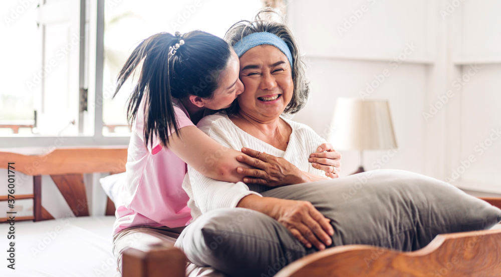 Obraz premium Portrait of enjoy happy love asian family senior mature mother and young daughter smiling laughing embracing and having fun together in moments good time at home