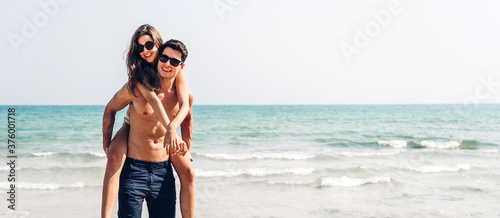 Photography Vacation romantic lovers young happy couple hug and standing on sand at sea having fun and relaxing together with copy space banner for adding text on tropical beach