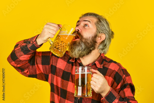 Taste your imaginations. Alcoholic. Thirsty man drinking beer in pub bar. Beer with foam. Hipster drink beer. Mature bearded guy hold beer glass. Cheers toast. Holiday celebration. Bachelor day photo