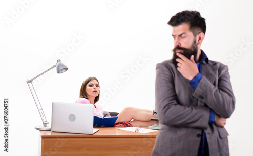 Office manager or secretary. Sexy lady office worker. Personal secretary. Typical office life. Office collective concept. Working together. Manager boss stand in front of girl busy with laptop