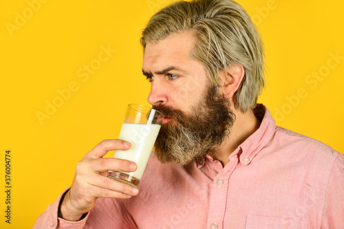 Pasteurized milk. Emotional bearded man hold glass of milk. Vegan milk concept. Vegan milks made from wide variety of beans nut, seeds and grains. Healthy food. Drink protein cocktail. Lactose free