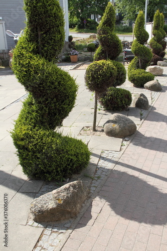a modern front yard with stones and plants
