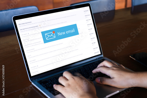 Person using a laptop computer with email communication connection message online and chat on social media with global letters concept. Laptop mockup with clipping path on screen.