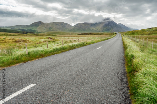 Small asphalt road in Connemara  county Galway  Ireland  Nobody  Dramatic cloudy sky.