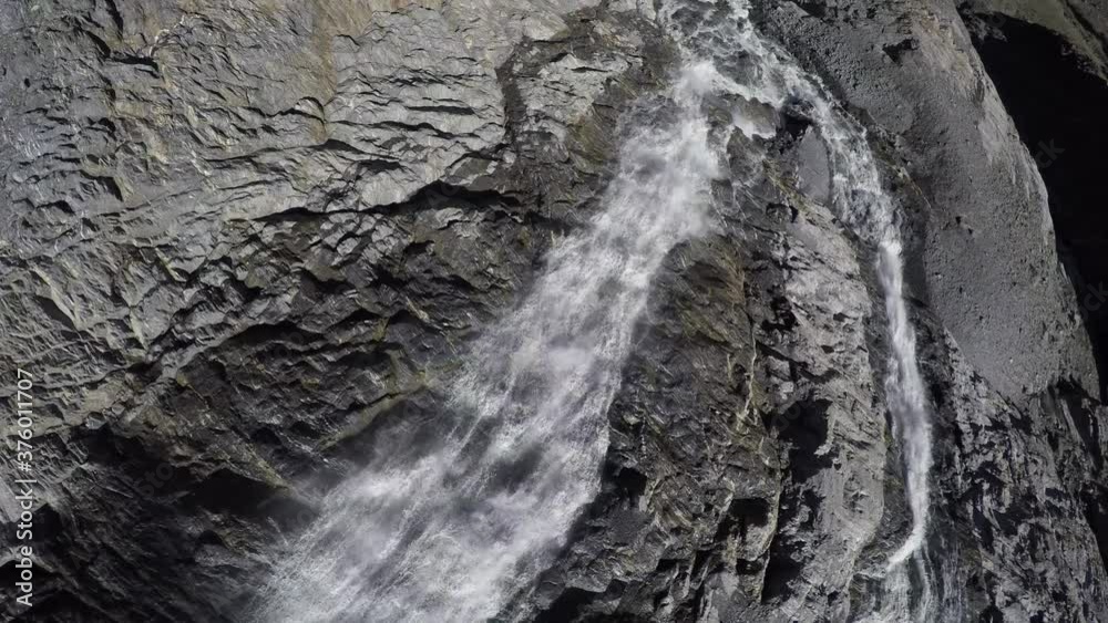Caucasus, Ossetia. Tsey gorge. Waterfall on the rocks under the Skaz glacier. Caucasus, Ossetia. Tsey gorge. Waterfall on the rocks under the Skaz glacier.