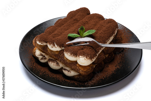 portion of Classic tiramisu dessert on ceramic plate isolated on white background with clipping path