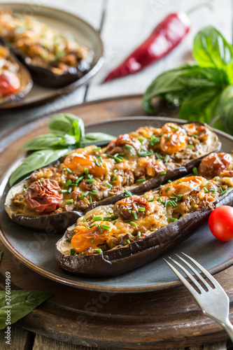 Baked eggplant. aubergine stuffed with vegetables and cheese