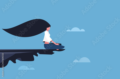 A girl doing meditation on the edge of a cliff