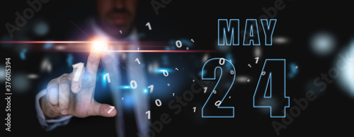 may 24th. Day 24 of month,advertising or high-tech calendar, man in suit presses bright virtual button spring month, day of the year concept