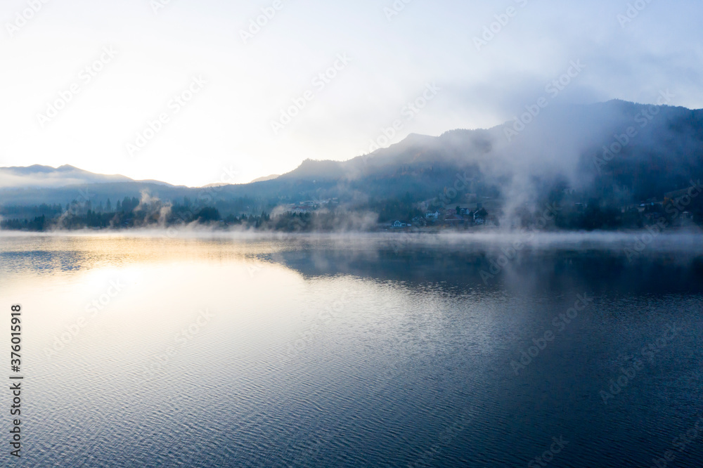Lovely autumnal landscape with fog over the lake. Lovely autumnal landscape with fog over the lake.