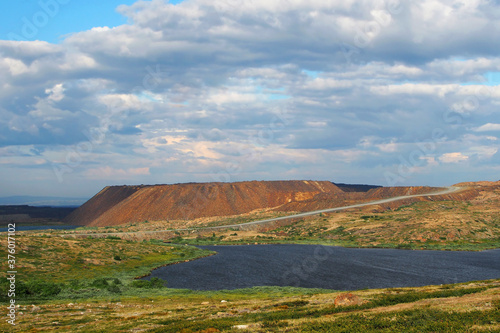 Piles of rock. Iron ore mining. The landscape of the Arctic tundra photo