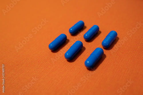 Blue pills on the orange background