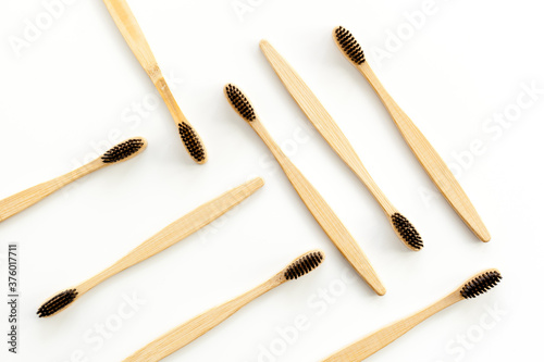 Eco materials concept with bamboo tooth brush on white background top view copy space