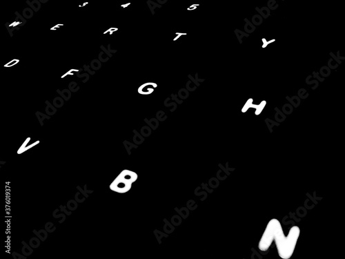 Creative Fine Art Image Illustration of White Glowing English Alphabet Letters On Dark Black Background Copy Space For Text. Modern abstract front style in computer keyboard typewriter sequence order.
