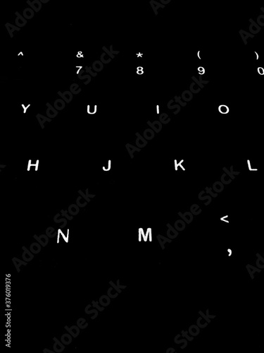 Creative Fine Art Image Illustration of White Glowing English Alphabet Letters On Dark Black Background Copy Space For Text. Modern abstract front style in computer keyboard typewriter sequence order.