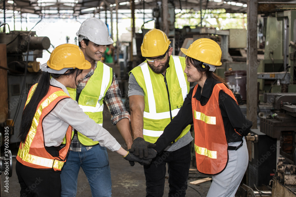 Factory workers are showing teamwork in the warehouse. Factory workers are showing teamwork in the warehouse.