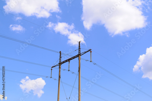 Bottom view of a high-voltage pole against the sky. Electricity © YAROSLOVEPHOTOVIDEO
