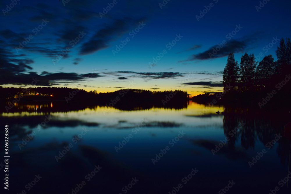 Sunset over the lake with reflection located in Tampere, Finland