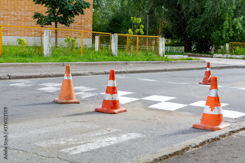 road repairs, orange cone in front of a speed bump. Line art red set.