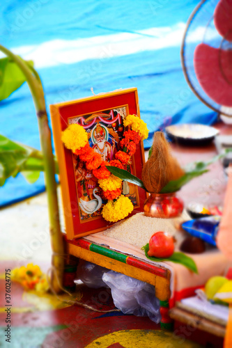 Vishwakarma Photo Surrounded with Rice, Leaf, Coconut, Kalash During Holly Pooja Zoom View photo