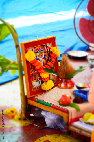 Vishwakarma Photo Surrounded with Rice, Leaf, Coconut, Kalash During Holly Pooja Zoom View