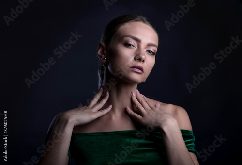 Portrait of a young girl on a dark background, studio shooting