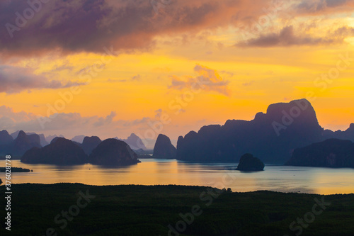 Sea bay silhouette morning sunrise with mountain photo