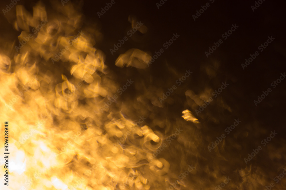 Abstract background with defocused streaks of light in the dark. Abstract image of night lights with motion blur.