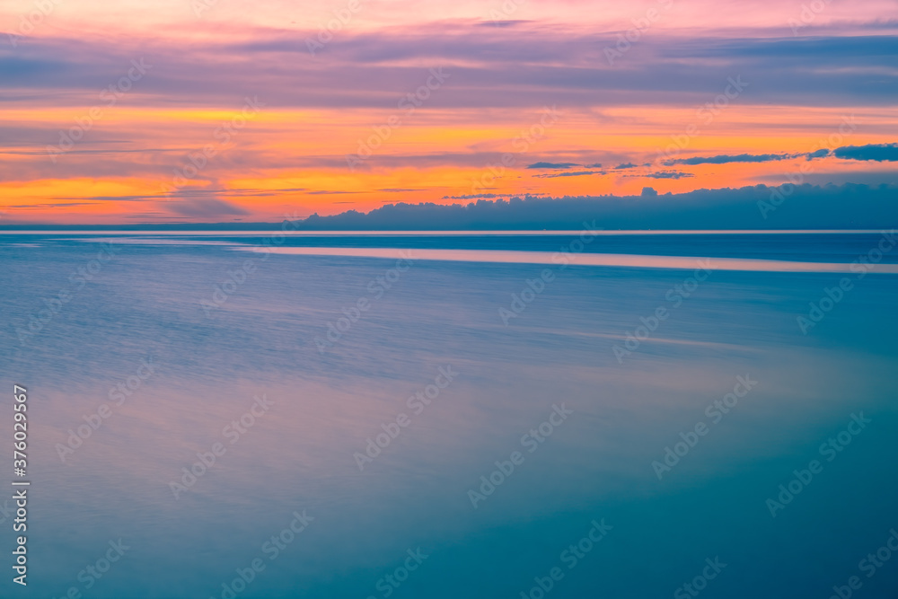 Minimalist sunset over water with copy space