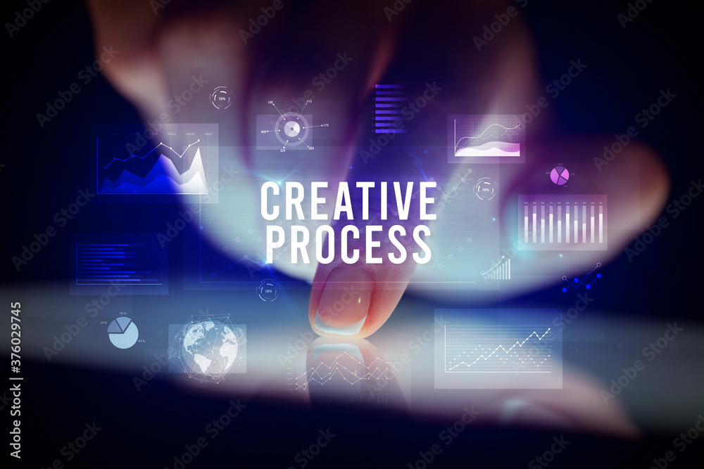 Finger touching tablet with charts and CREATIVE PROCESS inscription, business concept Finger touching tablet with charts and CREATIVE PROCESS inscription, business concept