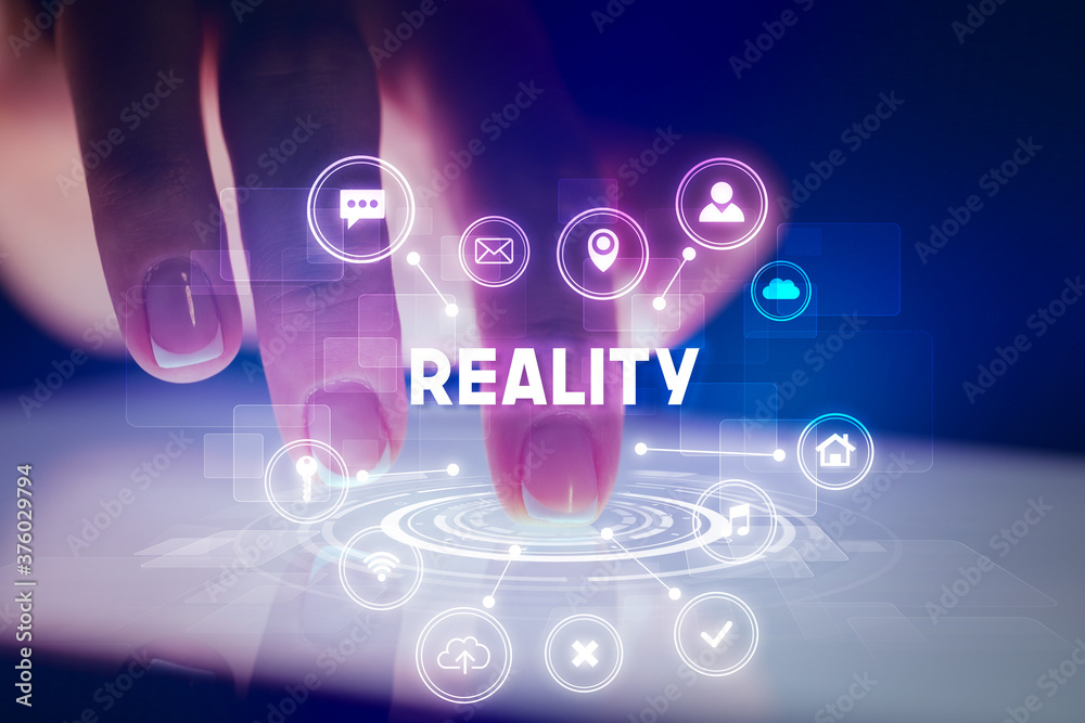 Finger touching tablet with web technology icons and REALITY inscription, web technology concept Finger touching tablet with web technology icons and REALITY inscription, web technology concept