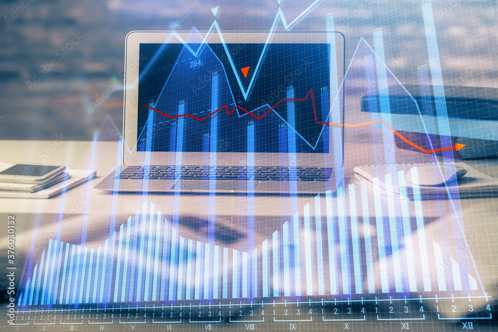 Double exposure of chart and financial info and work space with computer background. Concept of international online trading. Double exposure of chart and financial info and work space with computer background. Concept of international online trading.