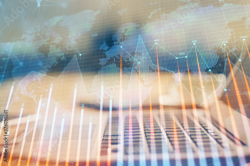 Financial graph colorful drawing and table with computer on background. Double exposure. Concept of international markets.
