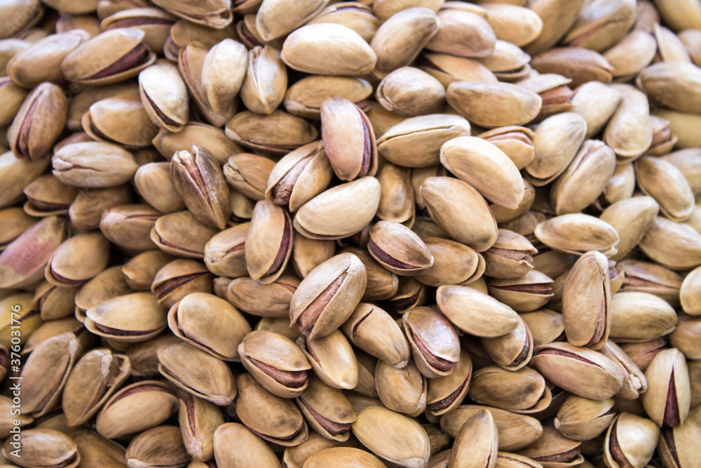 Pistachios are scattered on the table. Background for design Pistachios are scattered on the table. Background for design