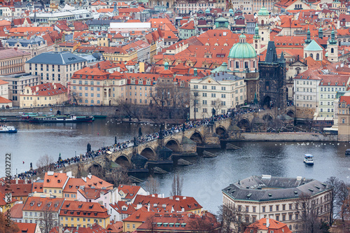Aerial view of Charles Bridge over Vltava river and cityscape of Prague old town with historic buildings from Petrin Hill on the day with Czech Republic
